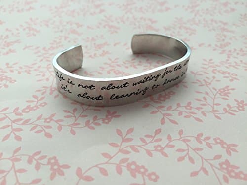 Hand Stamped Cuff, "Life is not about waiting for the storm to pass, it’s about learning to dance in the rain" with storm/ lightening, umbrella and music note design